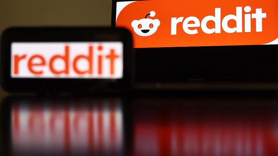 In this photo illustration, the Reddit logo is displayed on a cell phone and computer monitor on Fe...